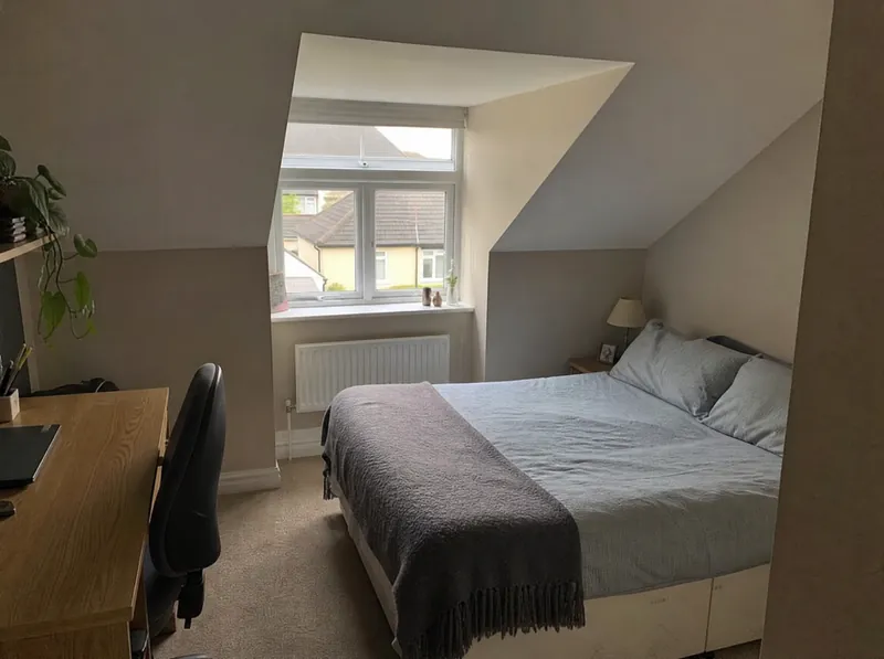 Finished attic bedroom with a dormer window in an Irish semi-detached house