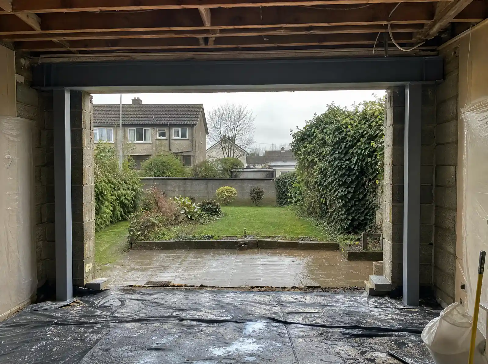 Steel goalpost frame in a widened rear wall opening ready for sliding doors in an Irish semi